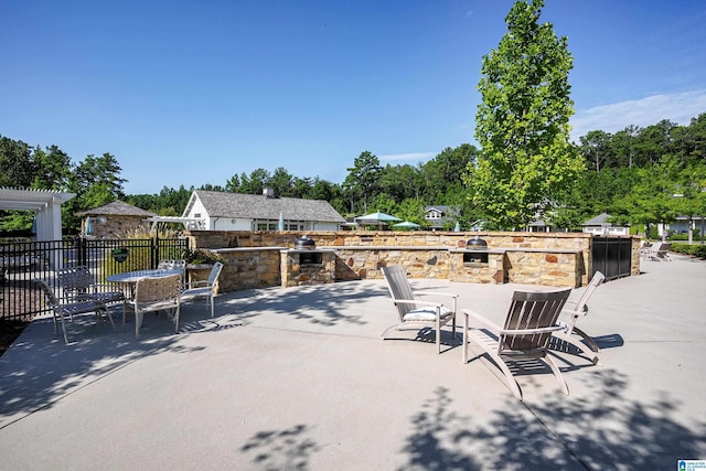 view of patio / terrace featuring an outdoor kitchen and fence