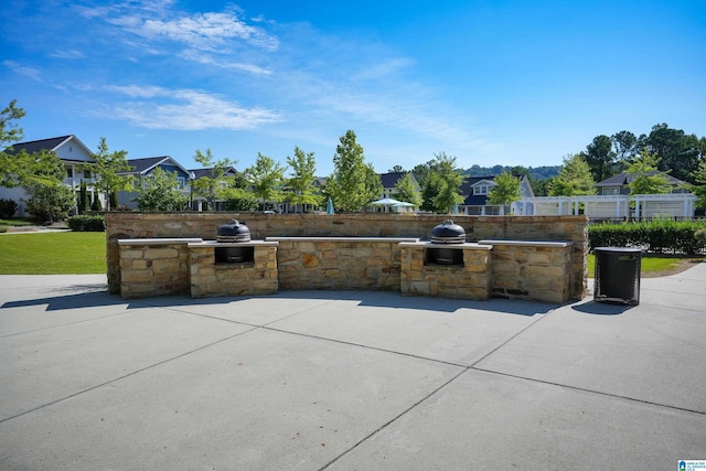 view of patio with a residential view, fence, and area for grilling