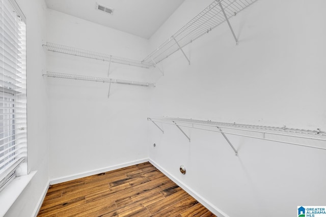 spacious closet featuring visible vents and wood finished floors