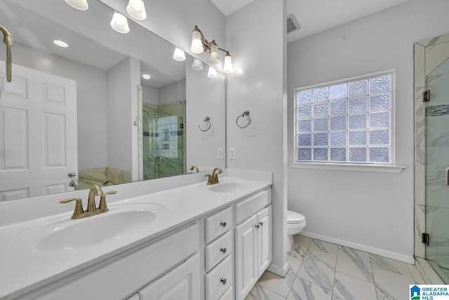 full bathroom featuring marble finish floor, double vanity, a sink, a shower stall, and baseboards