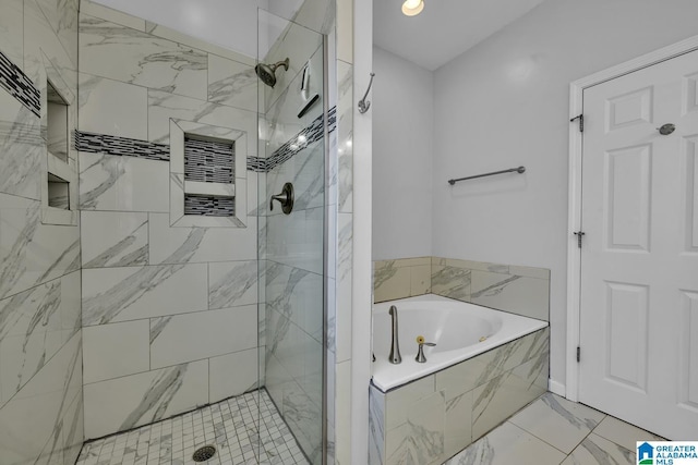 bathroom with a stall shower, marble finish floor, and a garden tub