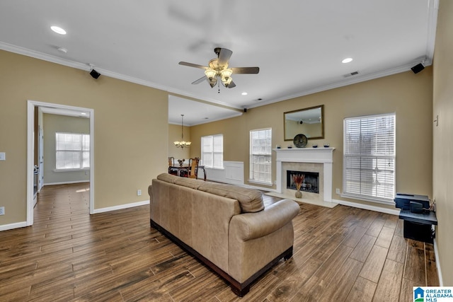 living room with visible vents, dark wood finished floors, and ornamental molding