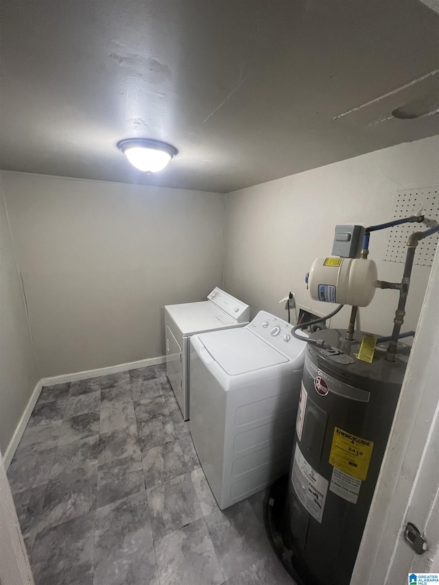 laundry room with water heater, washing machine and clothes dryer, laundry area, and baseboards