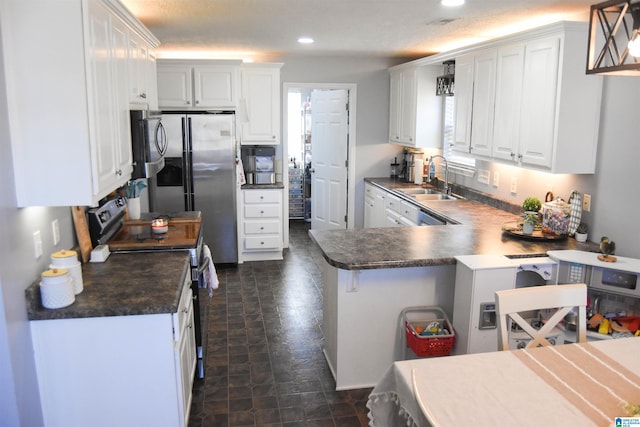 kitchen with electric range, dark countertops, a peninsula, white cabinetry, and a sink