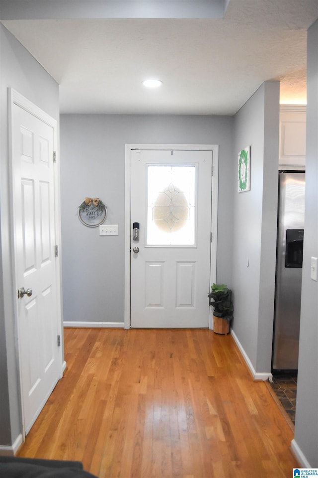 entrance foyer featuring light wood finished floors and baseboards