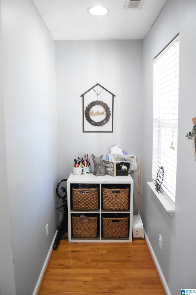 interior space with baseboards and wood finished floors