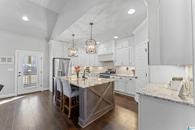 kitchen with recessed lighting, dark wood-style flooring, white cabinetry, appliances with stainless steel finishes, and light stone countertops