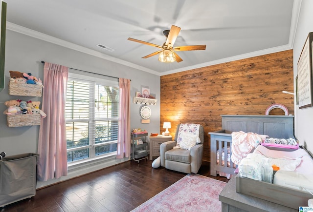 bedroom with ceiling fan, ornamental molding, wood finished floors, and visible vents