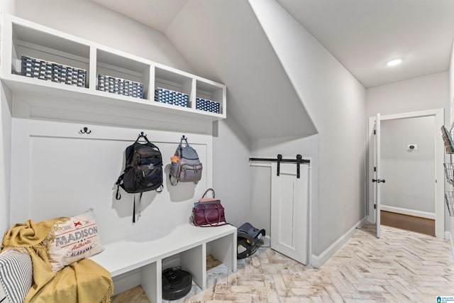 mudroom featuring a barn door, baseboards, and recessed lighting