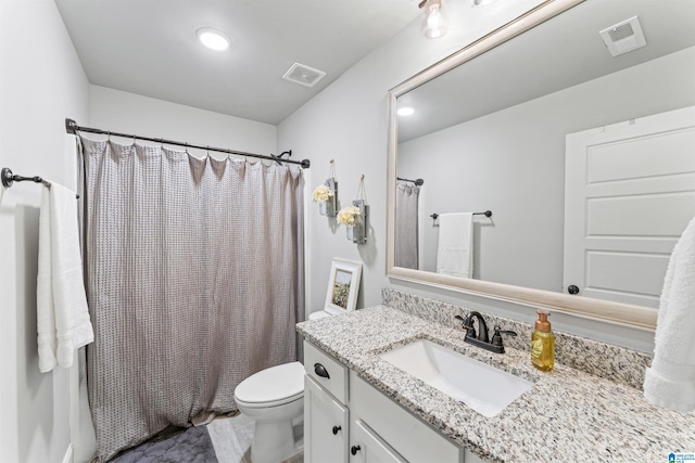 full bathroom featuring toilet, vanity, visible vents, and a shower with curtain