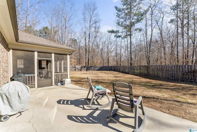 view of patio / terrace featuring a sunroom and a fenced backyard