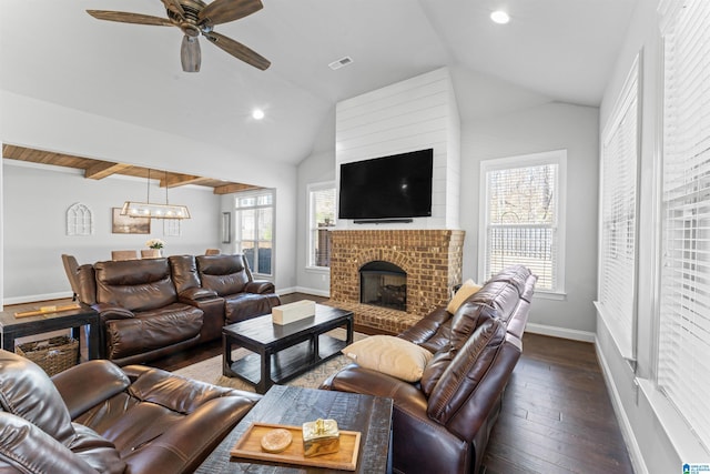 living room with a fireplace, baseboards, vaulted ceiling, and dark wood finished floors