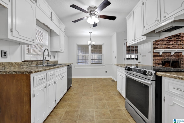 kitchen with white cabinets, stainless steel appliances, a sink, and ceiling fan with notable chandelier