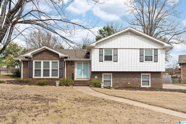 split level home with entry steps, french doors, and brick siding