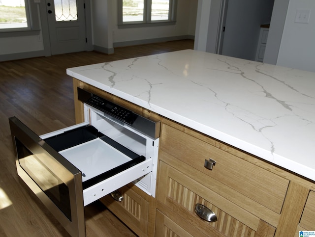 kitchen featuring light wood finished floors and light stone countertops