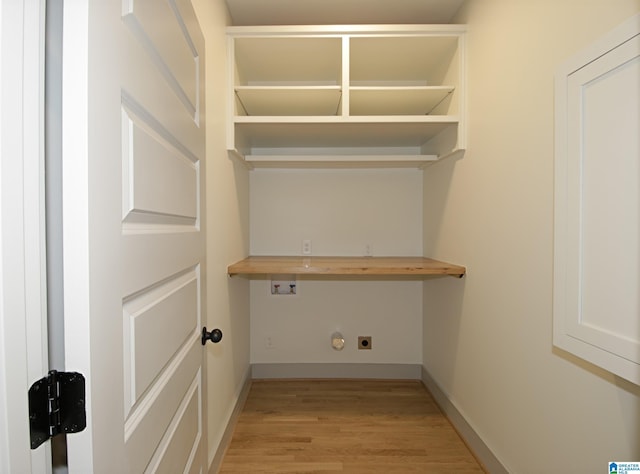 clothes washing area with laundry area, baseboards, hookup for an electric dryer, light wood-type flooring, and washer hookup