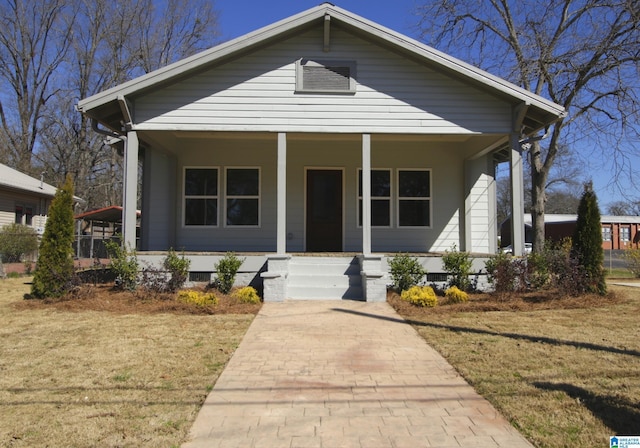 bungalow featuring a front lawn and a porch