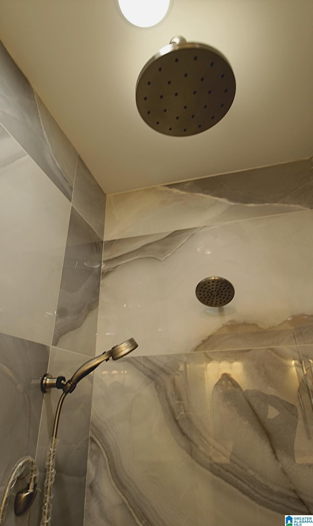 room details featuring a marble finish shower