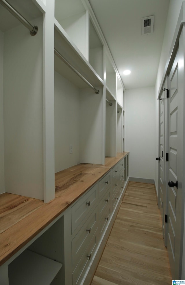 mudroom with light wood-style flooring and visible vents