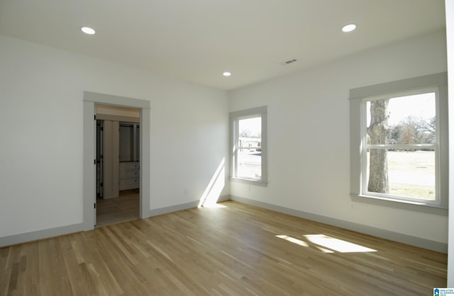 empty room with recessed lighting, plenty of natural light, and light wood-style flooring