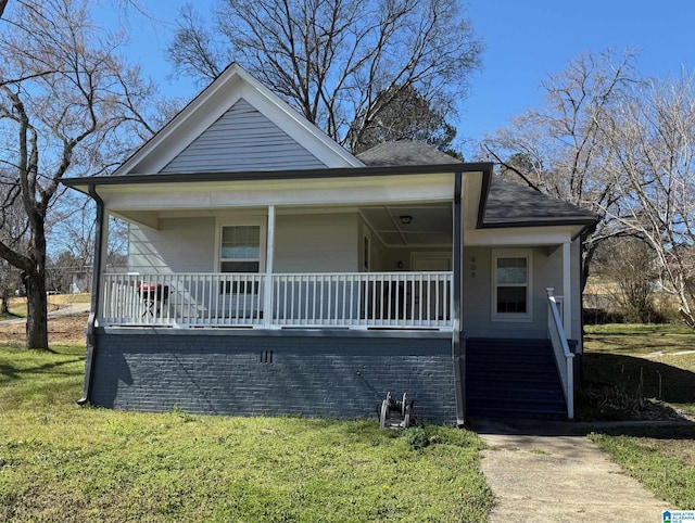 bungalow with a porch and a front lawn