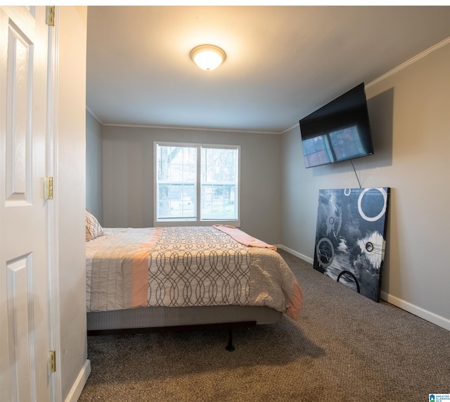 carpeted bedroom featuring baseboards and ornamental molding