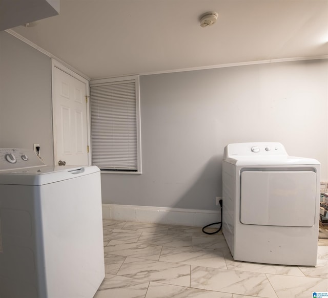 clothes washing area with baseboards, marble finish floor, laundry area, and washing machine and clothes dryer