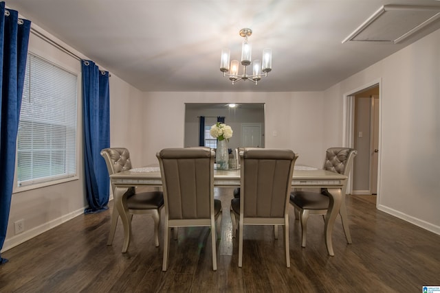 dining room with baseboards, a notable chandelier, and dark wood-style floors