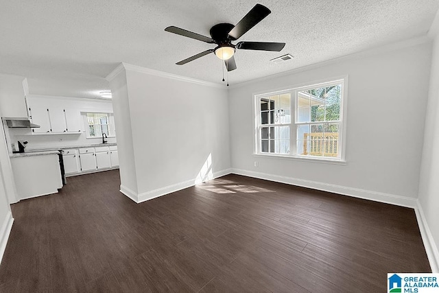 interior space with dark wood-style flooring, visible vents, crown molding, and a healthy amount of sunlight