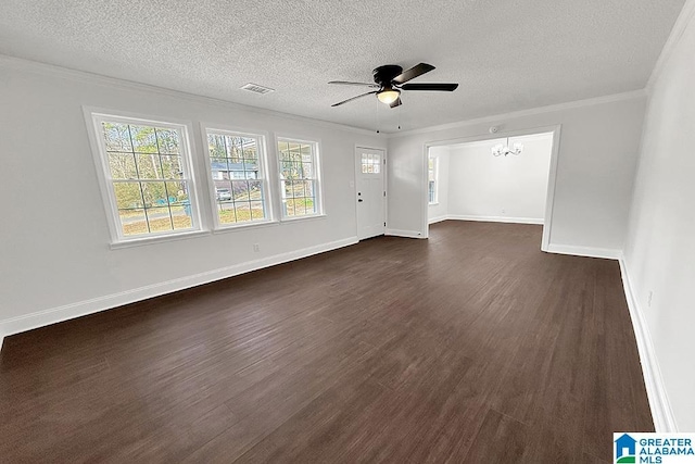 unfurnished living room featuring dark wood-style flooring, crown molding, visible vents, baseboards, and ceiling fan with notable chandelier