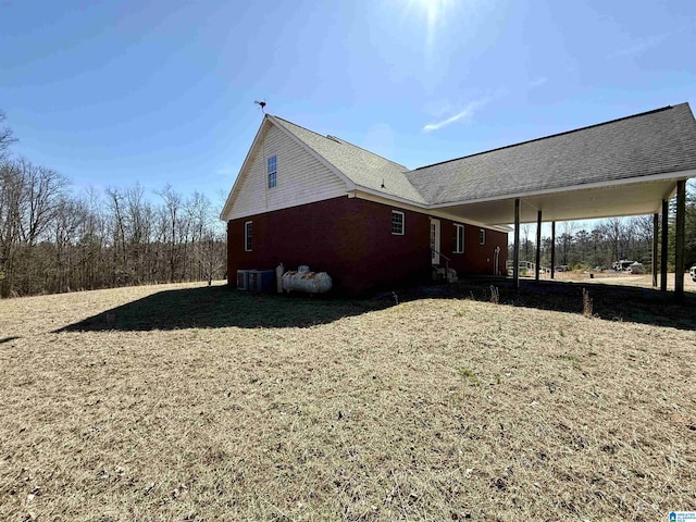 view of home's exterior featuring cooling unit and a yard