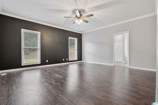 spare room featuring ornamental molding, a ceiling fan, a textured ceiling, wood finished floors, and baseboards