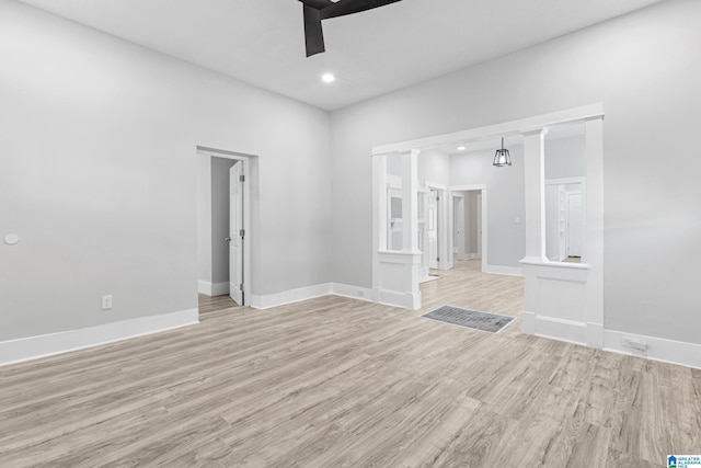 spare room with recessed lighting, baseboards, ceiling fan, light wood-type flooring, and ornate columns