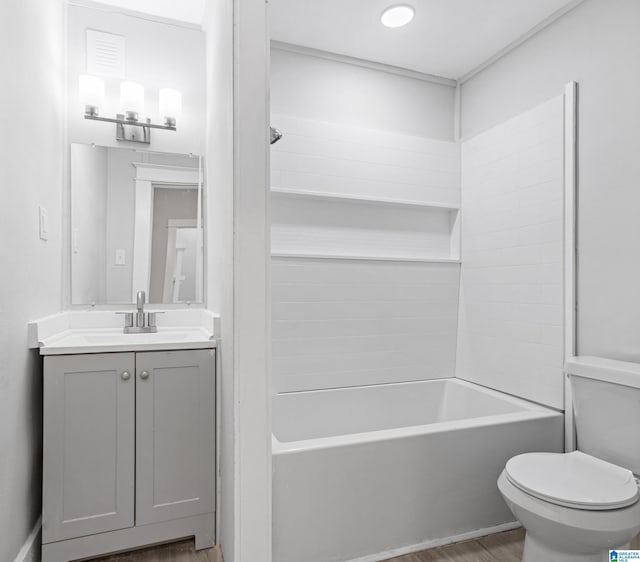 bathroom featuring visible vents, toilet, tub / shower combination, vanity, and wood finished floors