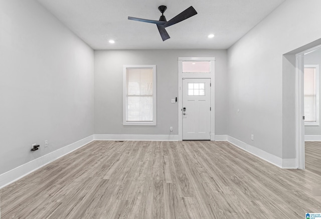 foyer featuring light wood-type flooring, ceiling fan, baseboards, and recessed lighting