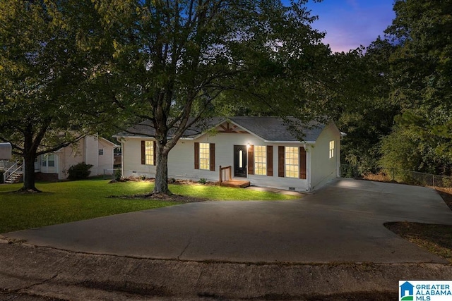 single story home with crawl space, a lawn, and fence