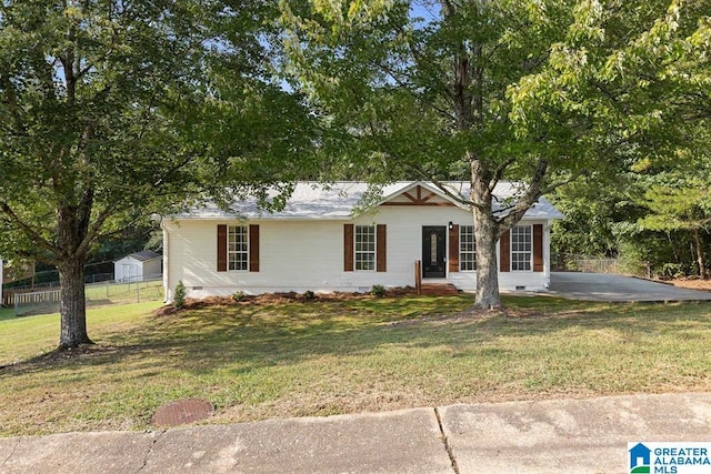 ranch-style home featuring crawl space, fence, and a front lawn