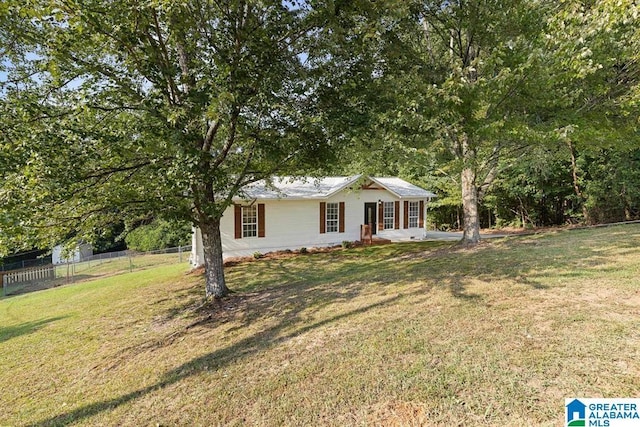 ranch-style house featuring a front yard and fence