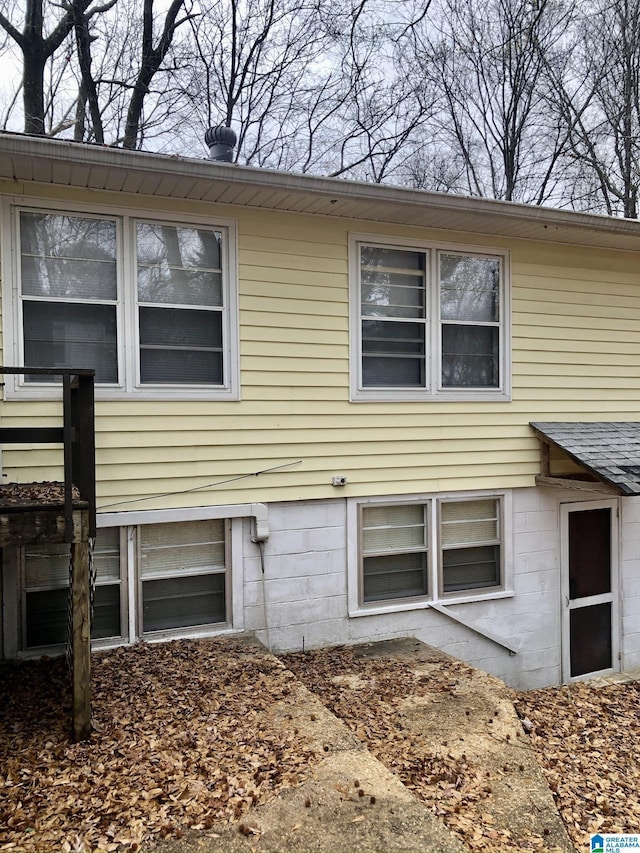 view of property exterior featuring a shingled roof