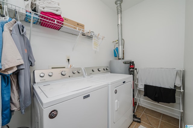 laundry area with washer and dryer, laundry area, water heater, and light tile patterned floors