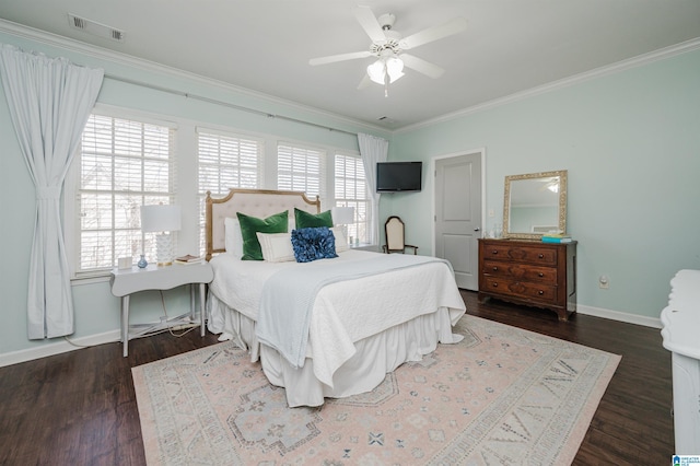 bedroom with baseboards, visible vents, crown molding, and wood finished floors