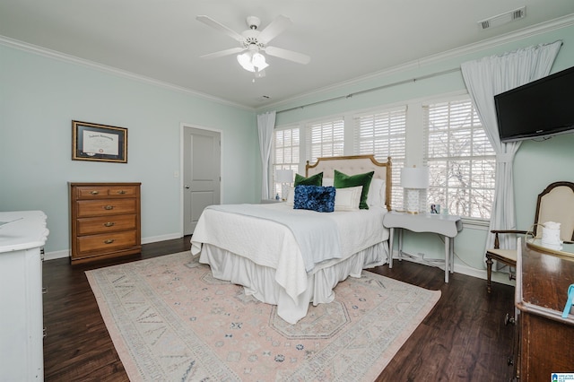 bedroom with visible vents, crown molding, baseboards, and wood finished floors