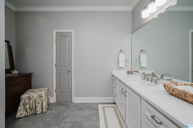 bathroom with crown molding, vanity, and baseboards