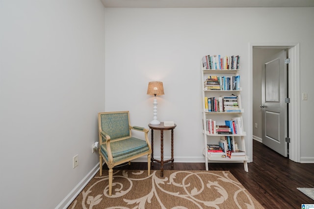 living area featuring baseboards and wood finished floors