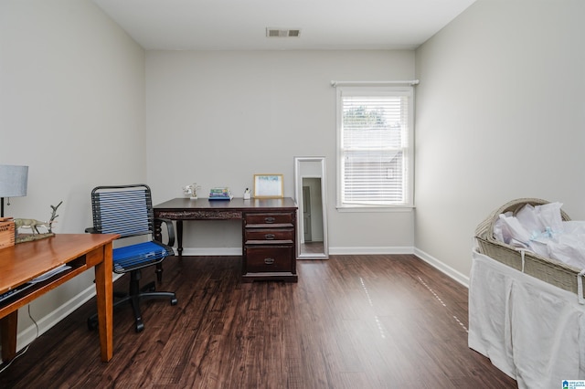 office area featuring dark wood finished floors, visible vents, and baseboards