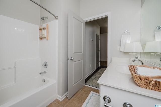 full bath with bathtub / shower combination, tile patterned flooring, vanity, and baseboards