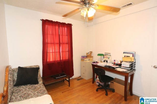 office with a ceiling fan, visible vents, and light wood finished floors