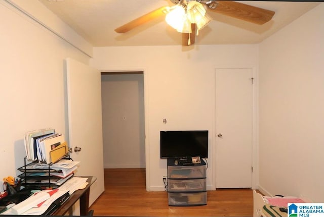 home office with a ceiling fan and wood finished floors