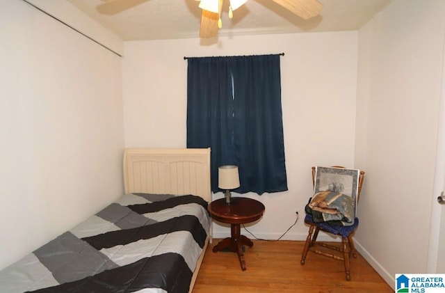 bedroom with baseboards, a ceiling fan, and wood finished floors