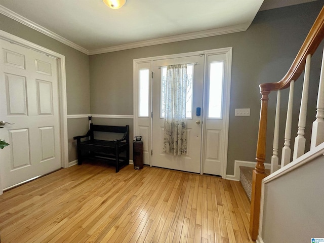 entryway with light wood-style flooring, stairway, baseboards, and ornamental molding